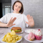 foods-to-avoid-during-period-portrait-beautiful-middleaged-brunette-woman-promoting-rejection-unhealthy-diet-harmful-junk-products