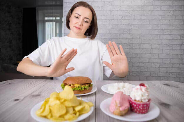 foods-to-avoid-during-period-portrait-beautiful-middleaged-brunette-woman-promoting-rejection-unhealthy-diet-harmful-junk-products