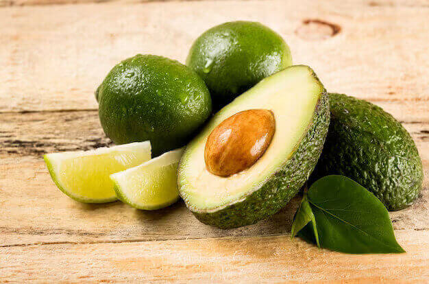 healthy food concept avocado lime slices wooden background