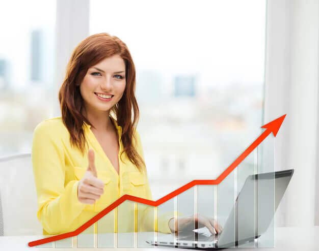 people technology statistic sand business concept smiling woman with laptop computer growth chart showing thumbs up home