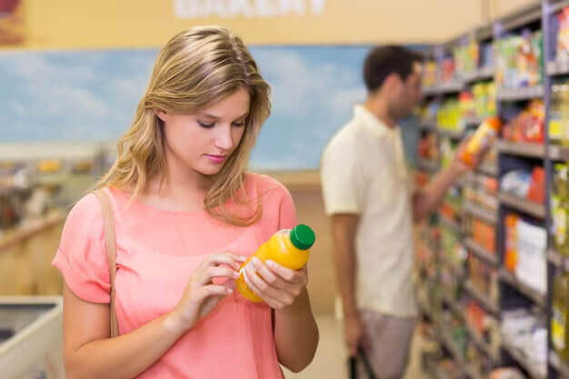pretty blonde woman read food labels